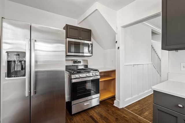 kitchen featuring appliances with stainless steel finishes, gray cabinets, dark wood-style flooring, and light countertops