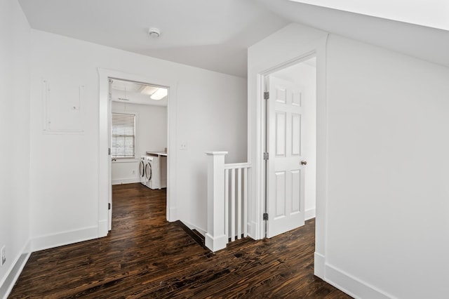 corridor with dark wood-style floors, baseboards, attic access, electric panel, and an upstairs landing