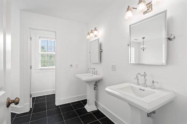 bathroom featuring tile patterned floors, baseboards, and a sink