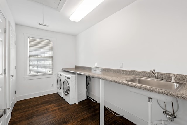 laundry area featuring visible vents, washer and clothes dryer, attic access, dark wood-style floors, and a sink