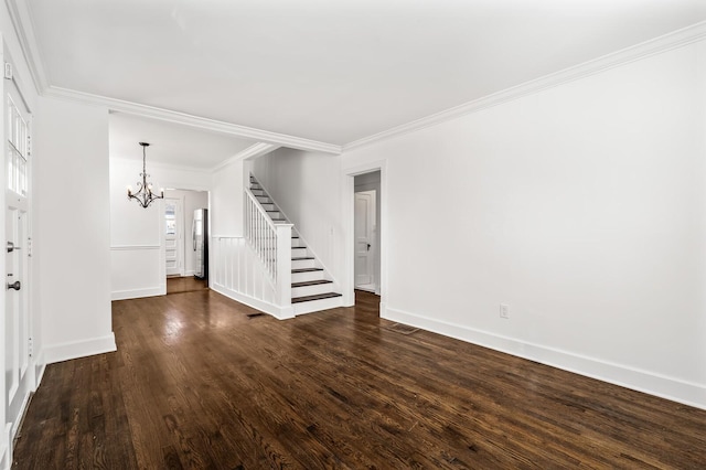 unfurnished living room featuring baseboards, ornamental molding, stairs, dark wood-type flooring, and a chandelier