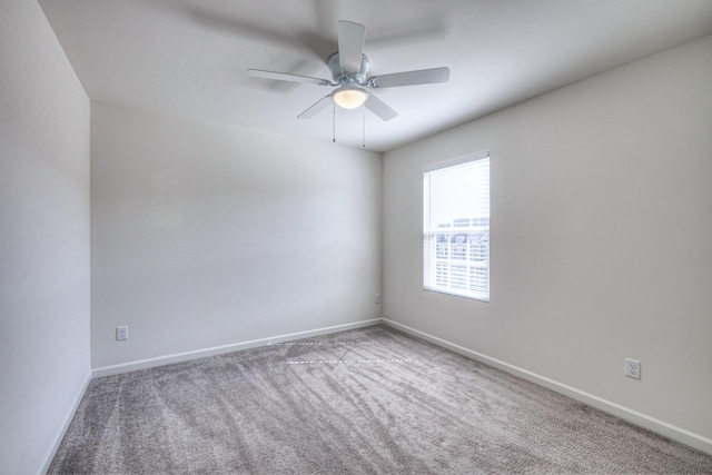 empty room with baseboards, ceiling fan, and carpet flooring