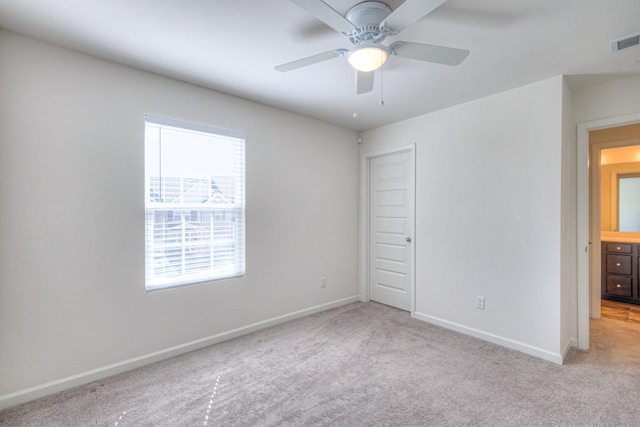 unfurnished bedroom featuring visible vents, baseboards, and light colored carpet