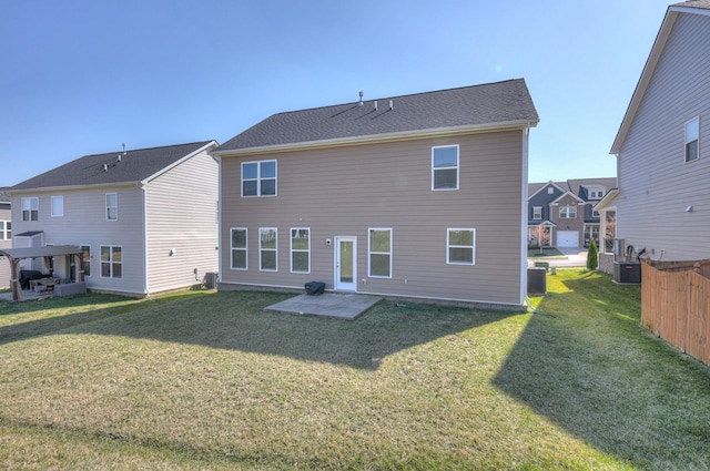 rear view of house featuring cooling unit, a lawn, and a patio area