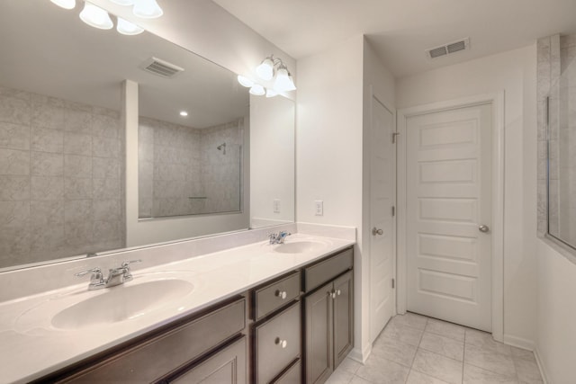 full bath with double vanity, visible vents, and a sink