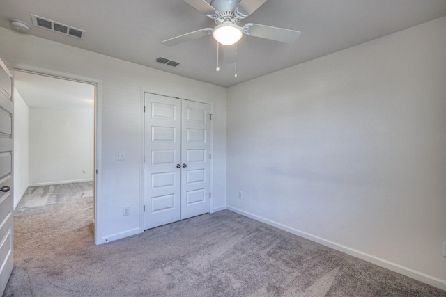 unfurnished bedroom featuring carpet flooring, baseboards, visible vents, and a closet