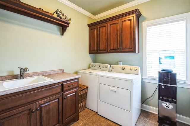 laundry room with light tile patterned flooring, cabinet space, a sink, crown molding, and washer and clothes dryer