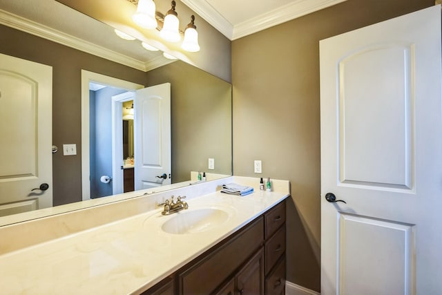 bathroom with vanity, crown molding, and a chandelier