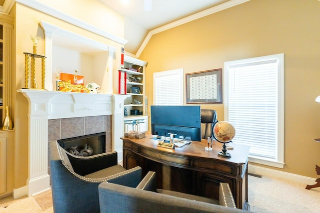 carpeted home office featuring visible vents, baseboards, lofted ceiling, ornamental molding, and a tile fireplace