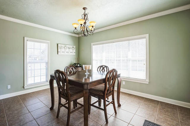 tiled dining area featuring baseboards, plenty of natural light, an inviting chandelier, and ornamental molding