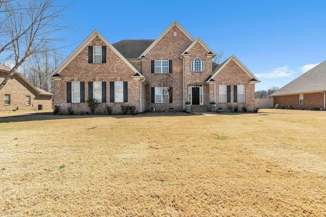 traditional home featuring brick siding, crawl space, and a front lawn