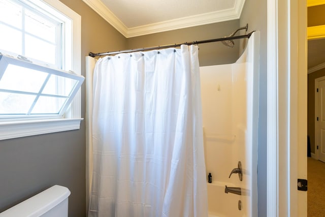 full bathroom with crown molding, toilet, and shower / bath combo with shower curtain