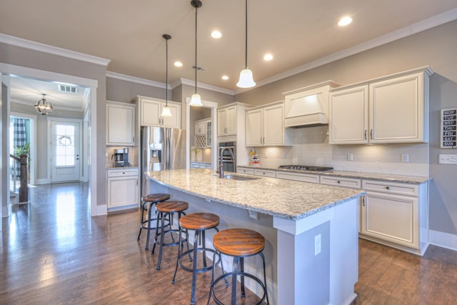 kitchen featuring custom range hood, a sink, tasteful backsplash, dark wood-style floors, and appliances with stainless steel finishes