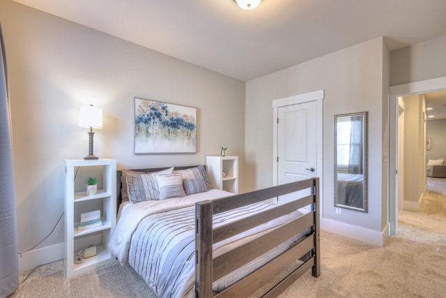 bedroom with baseboards and light carpet