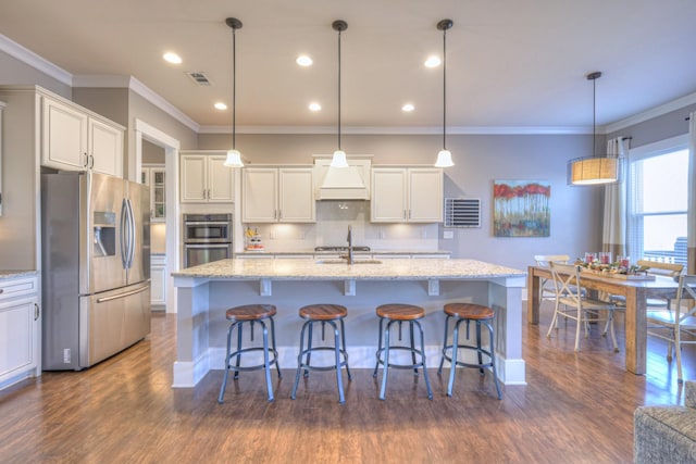 kitchen with visible vents, white cabinetry, stainless steel appliances, and ornamental molding