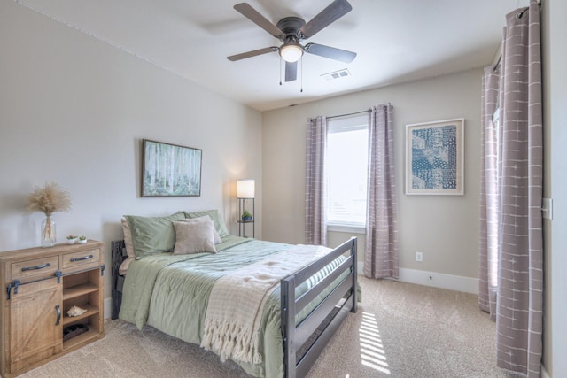 bedroom with visible vents, light carpet, baseboards, and ceiling fan