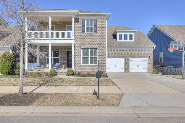 view of front of house featuring a balcony, driveway, a porch, an attached garage, and brick siding