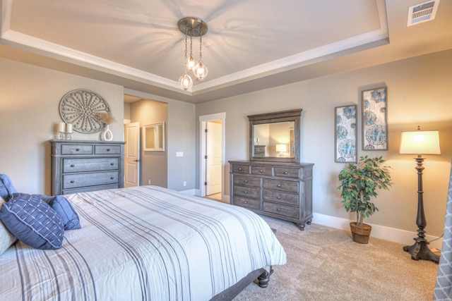 bedroom with a raised ceiling, baseboards, visible vents, and carpet floors