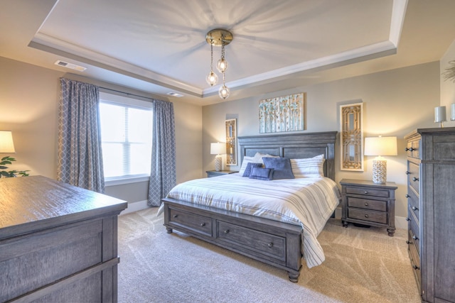 bedroom featuring light carpet, visible vents, and a raised ceiling