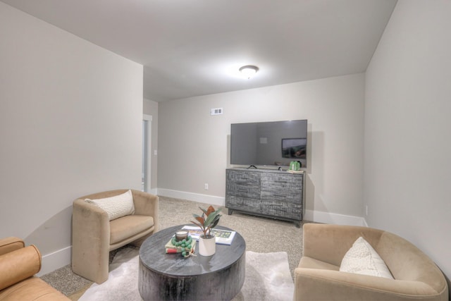 living area featuring baseboards and carpet floors