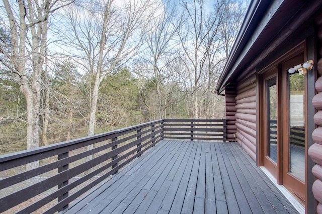 wooden deck with a view of trees