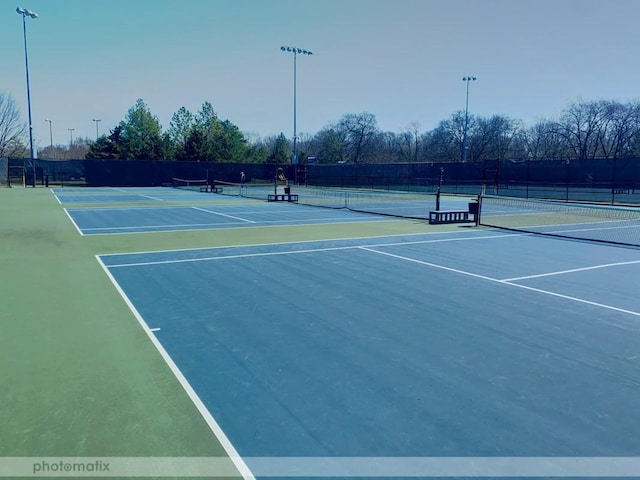 view of tennis court with fence