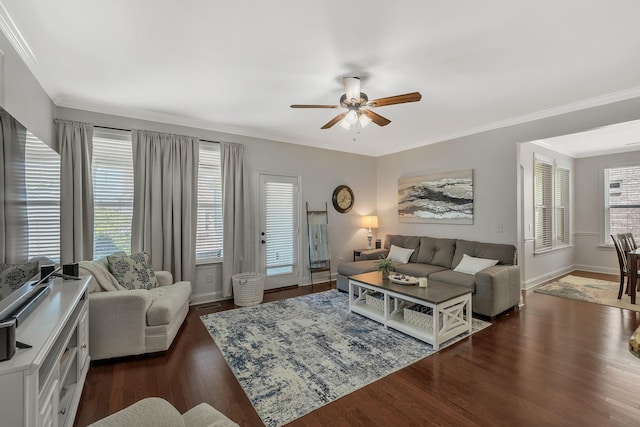 living area featuring visible vents, ornamental molding, dark wood finished floors, baseboards, and ceiling fan