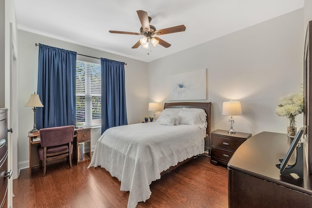 bedroom with baseboards, a ceiling fan, and dark wood-style flooring