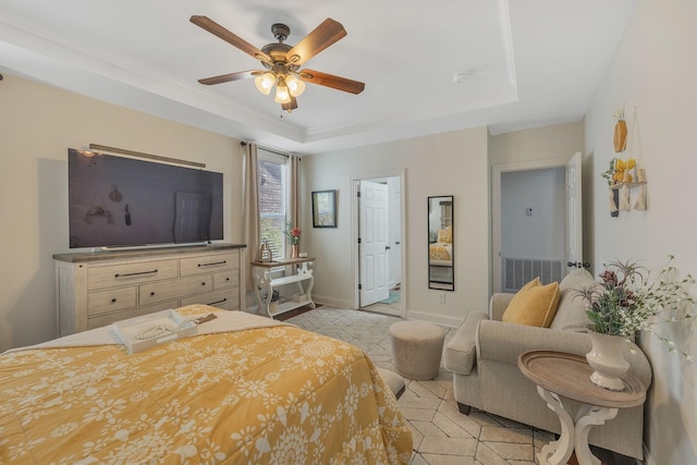 bedroom with visible vents, a raised ceiling, baseboards, and ornamental molding