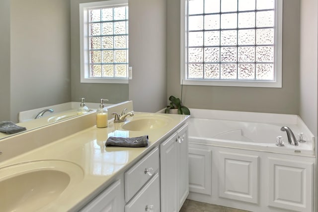 bathroom featuring a sink, a garden tub, and double vanity