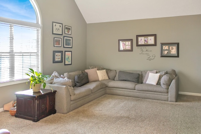 living room with vaulted ceiling, baseboards, and carpet floors