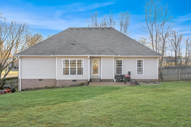 back of property featuring crawl space, a yard, and fence