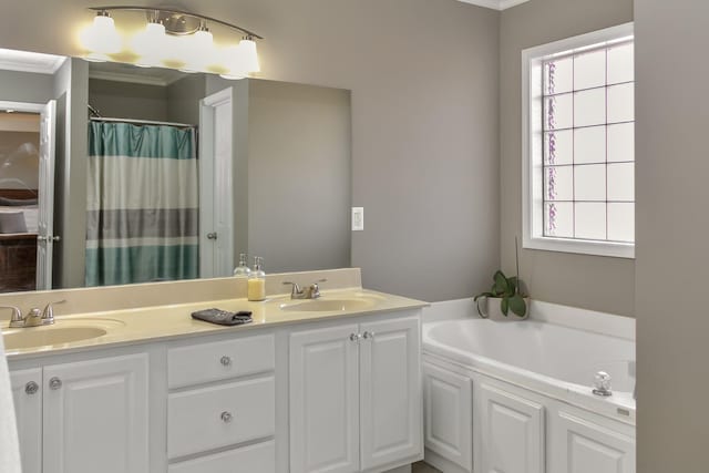 bathroom with a bath, double vanity, and a sink