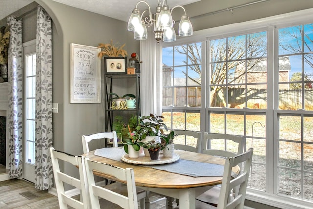 dining room with an inviting chandelier and wood finished floors