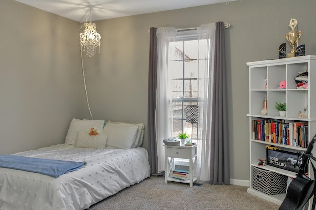 bedroom with carpet flooring and baseboards