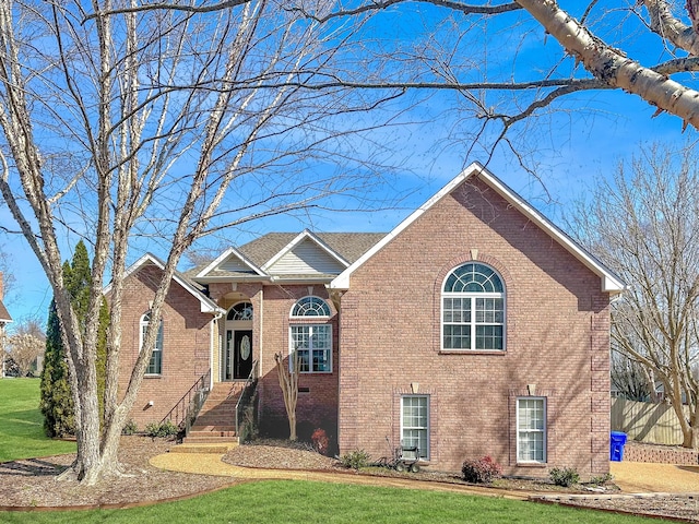 view of front of property with brick siding and a front yard