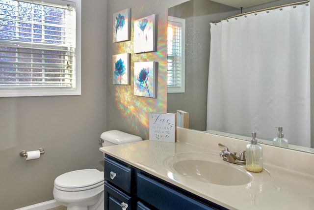 full bathroom with toilet and vanity