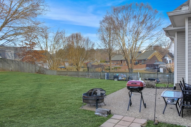 view of yard featuring a patio, a fire pit, and a fenced backyard