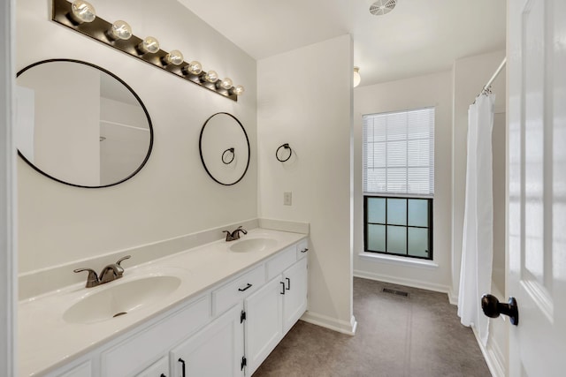 full bathroom with double vanity, visible vents, baseboards, and a sink