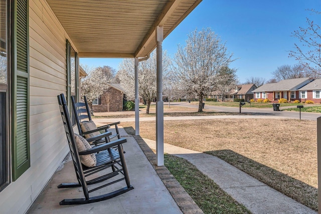 view of patio / terrace with a residential view and covered porch