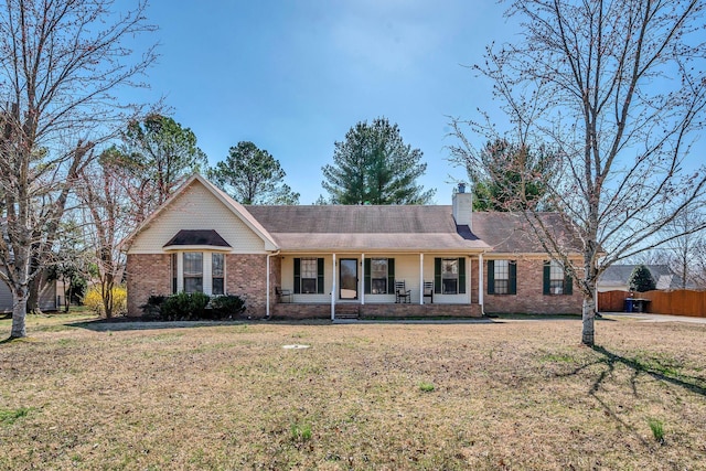 single story home with a front lawn, a porch, brick siding, and a chimney