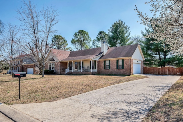 ranch-style house with brick siding, fence, covered porch, a chimney, and a garage