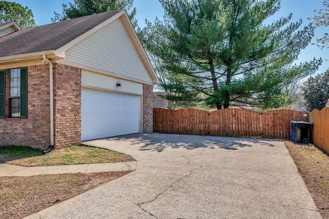 exterior space with driveway and fence