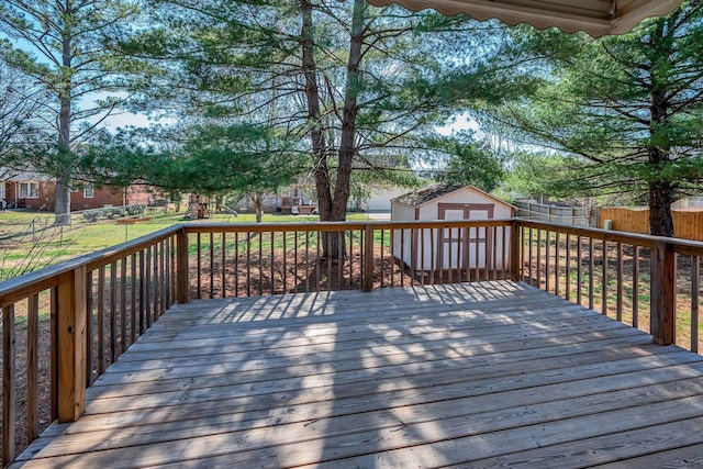 deck featuring an outbuilding, a fenced backyard, and a shed