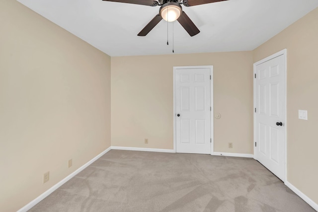 unfurnished bedroom with a ceiling fan, baseboards, and carpet floors