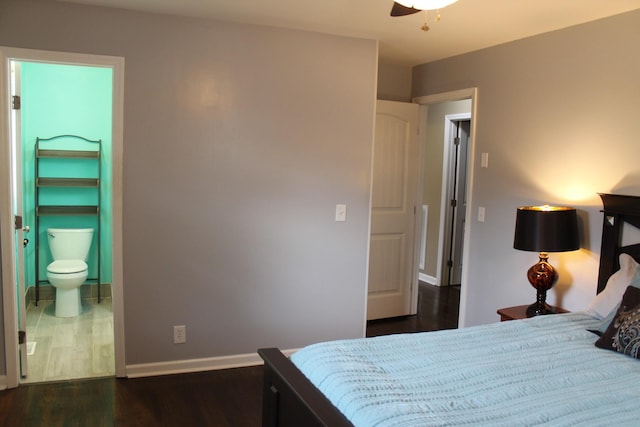 bedroom featuring dark wood finished floors, ensuite bath, and baseboards