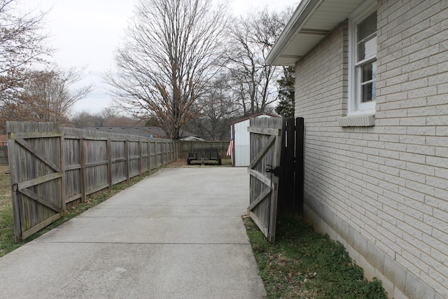 exterior space with driveway, an outdoor structure, and fence