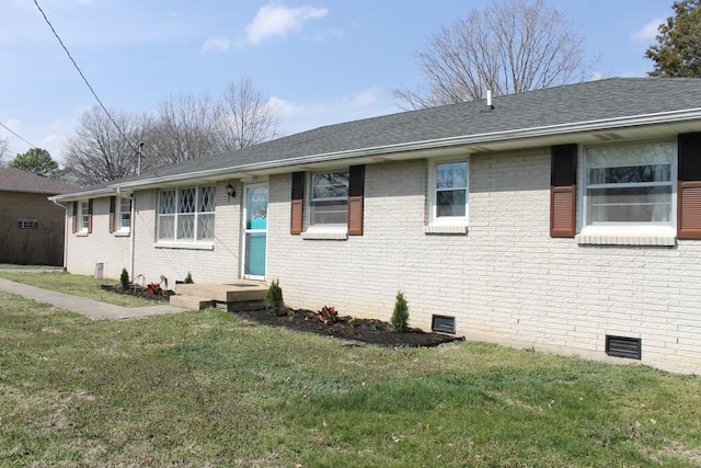 ranch-style house with crawl space, brick siding, a front lawn, and a shingled roof