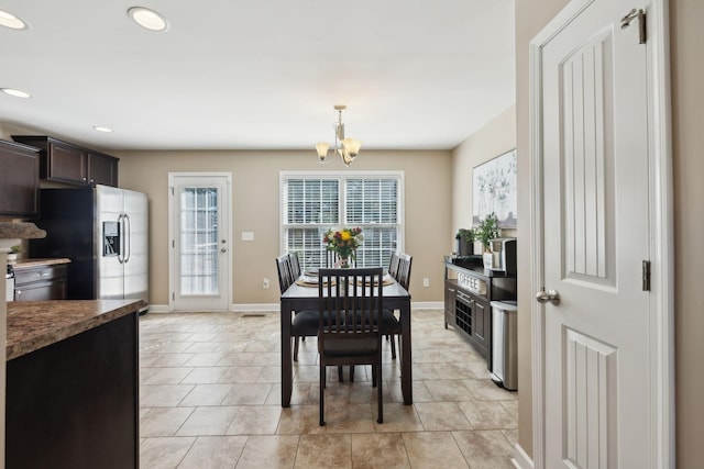 dining space with recessed lighting, baseboards, an inviting chandelier, and light tile patterned floors