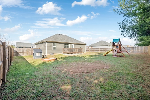 view of yard with a fenced backyard and a playground